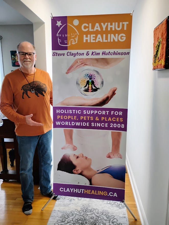 Steve beside our Clayhut banner